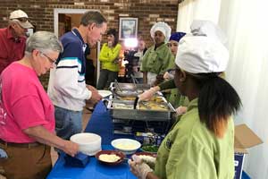 Culinary art students serving Habitat volunteers lunch