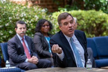 Senator Mark Warner sitting at table talking