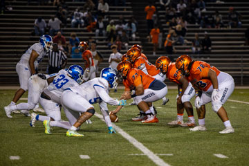 Heritage and E. C. Glass football players on field