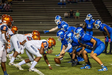 E. C. Glass and Heritage football teams lined up on the field