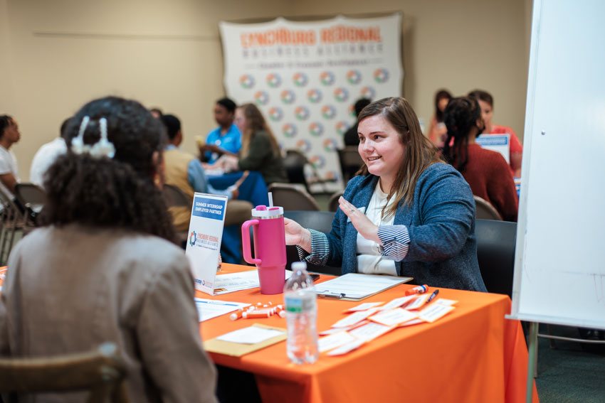 Woman interviewing students