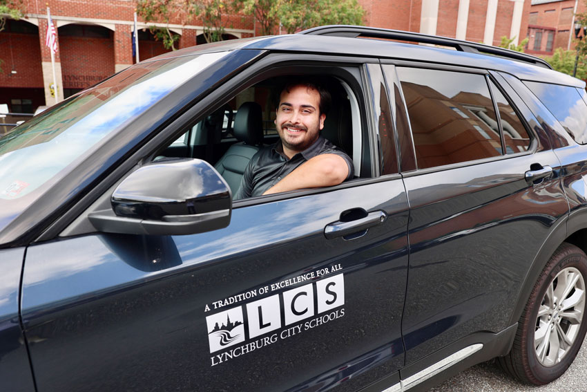 Smiling driver in vehicle with LCS logo