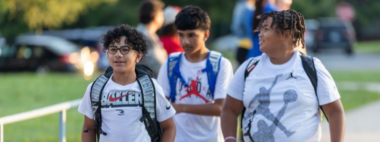 Three students walking into school